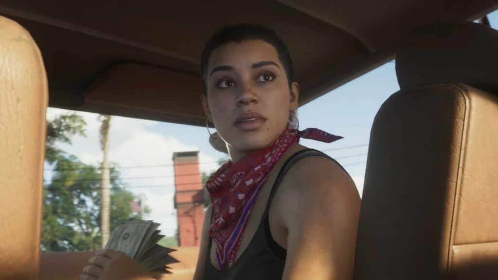 An image showing the GTA 6 protagonist Lucia sitting inside a car, looking back.