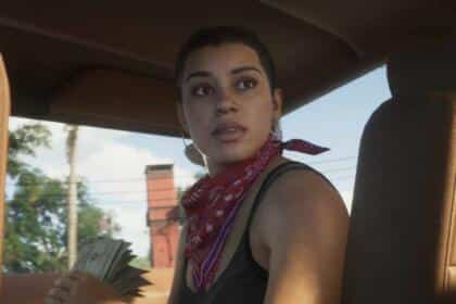 An image showing the GTA 6 protagonist Lucia sitting inside a car, looking back.