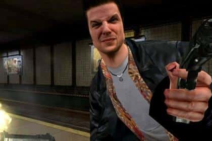 An image showing a screenshot from Max Payne 1 featuring Max squinting and shooting a gun.