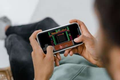 An image showing a person playing NES-Wordle on iPhone using the Delta Emulator.